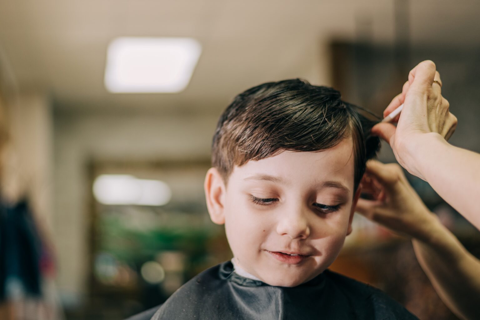 young-boy-getting-a-haircut-in-salon-2026-03-09-22-25-40-utc